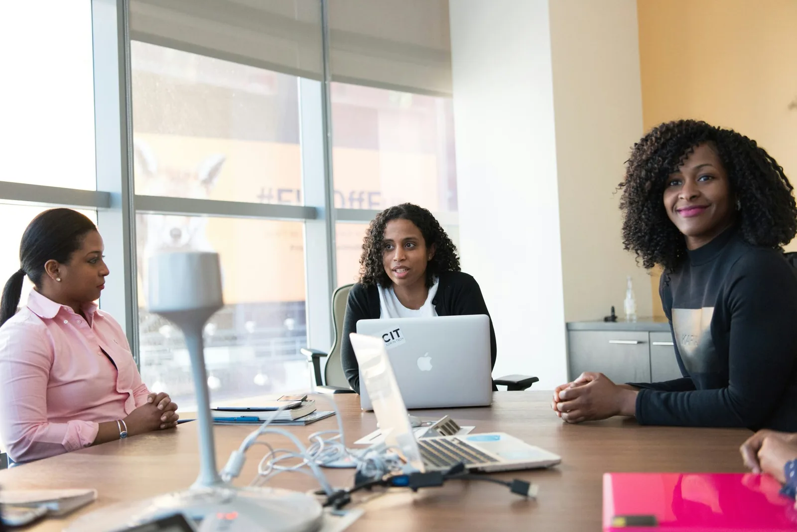 Three women in a meeting around a table