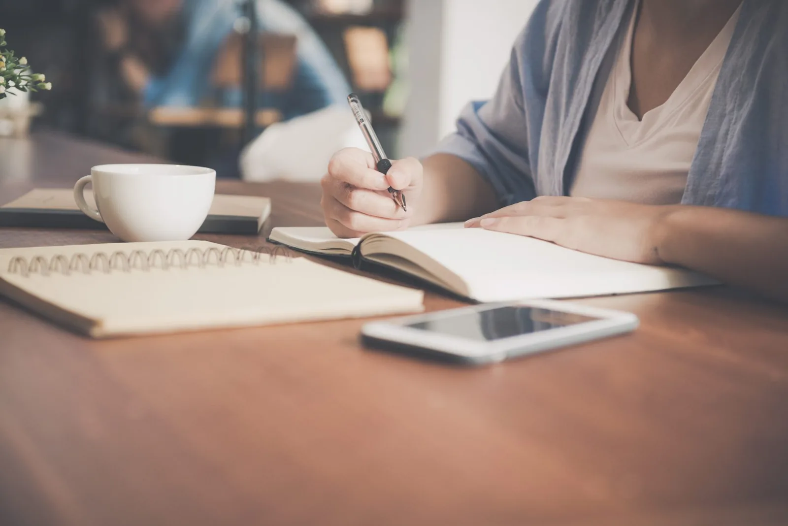 Notebook, pen and phone on a desk